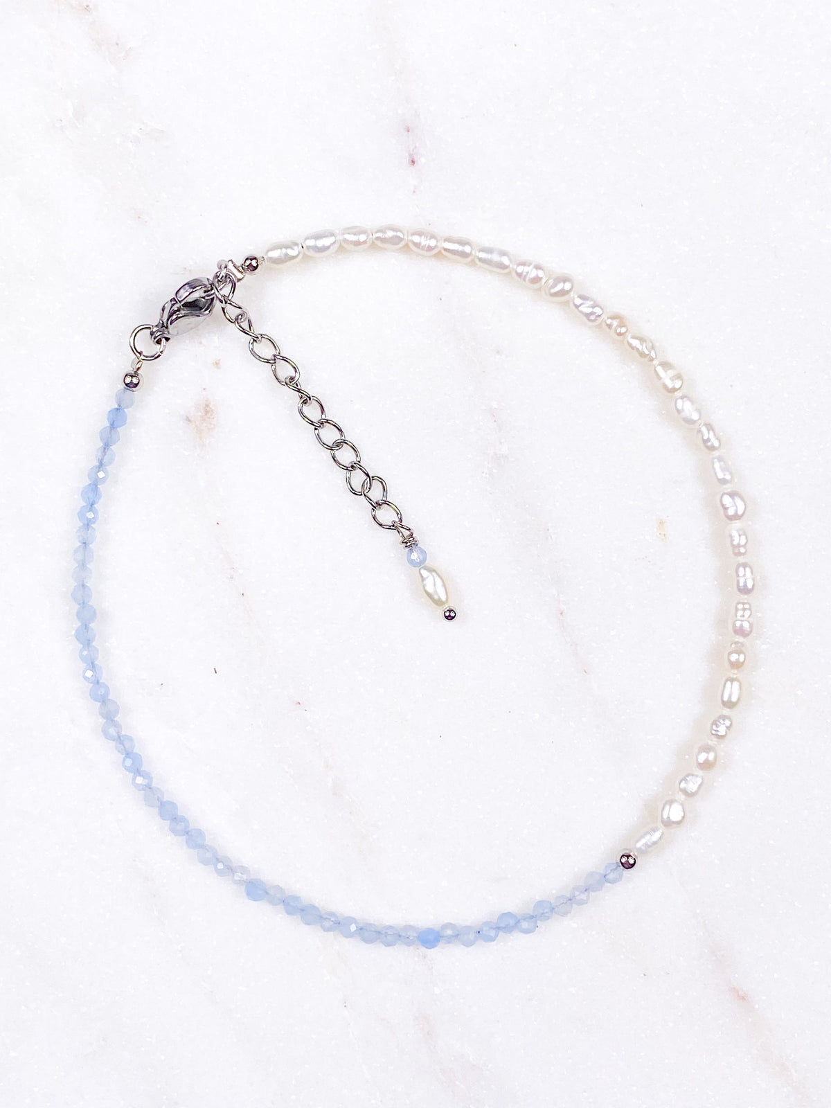 Fotlänk med akvamarinfasett och sötvattenspärla