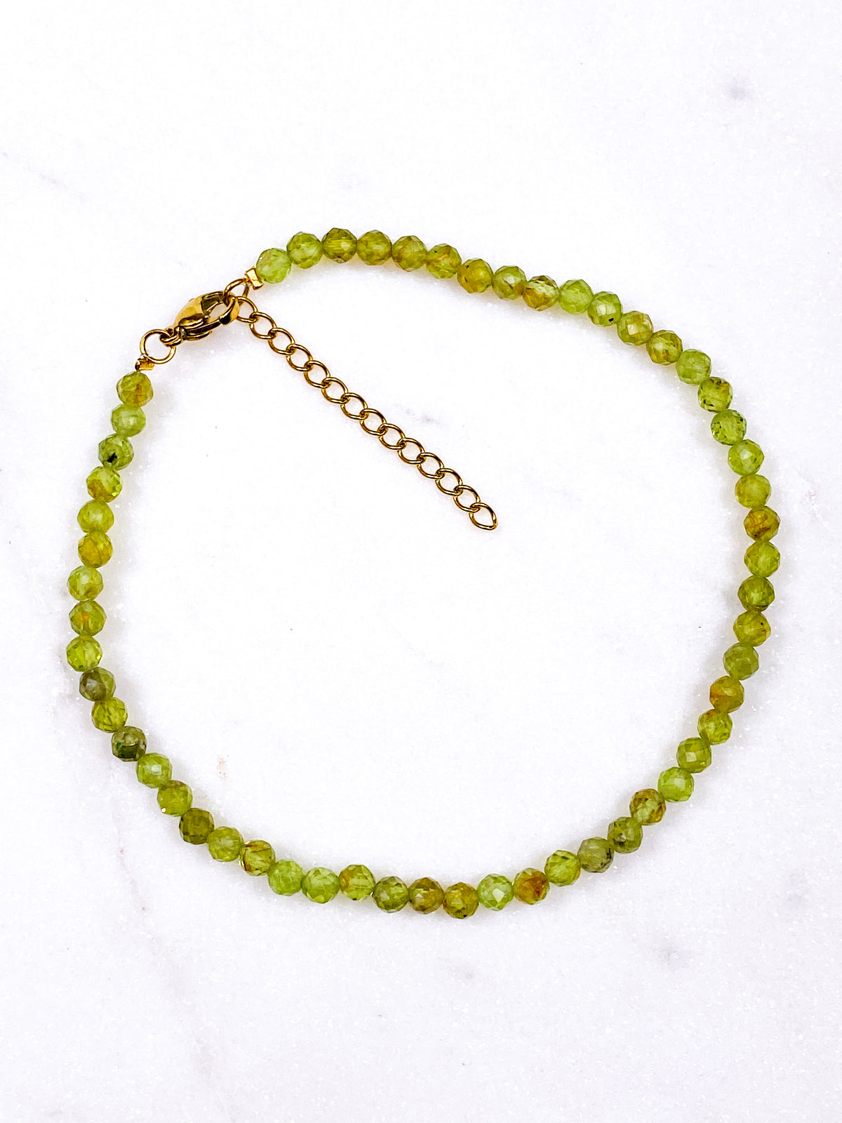 Peridot fasetterad fotlänk